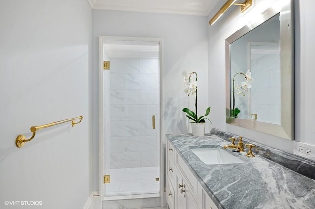 bathroom with vanity, crown molding, and a shower with door