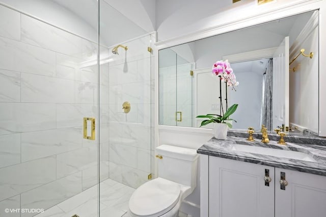 bathroom with vanity, toilet, and a shower with door