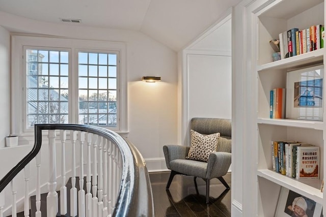 living area with vaulted ceiling and hardwood / wood-style floors