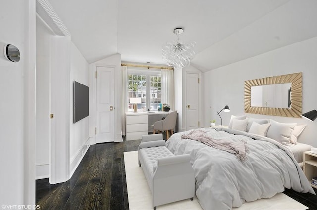 bedroom with lofted ceiling, dark hardwood / wood-style floors, and a notable chandelier