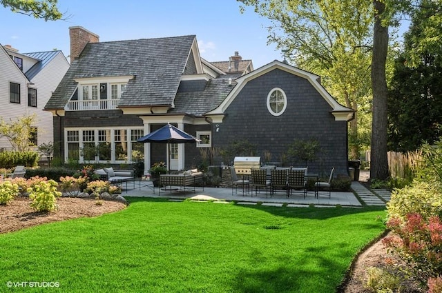 rear view of house with a yard, an outdoor hangout area, and a patio area