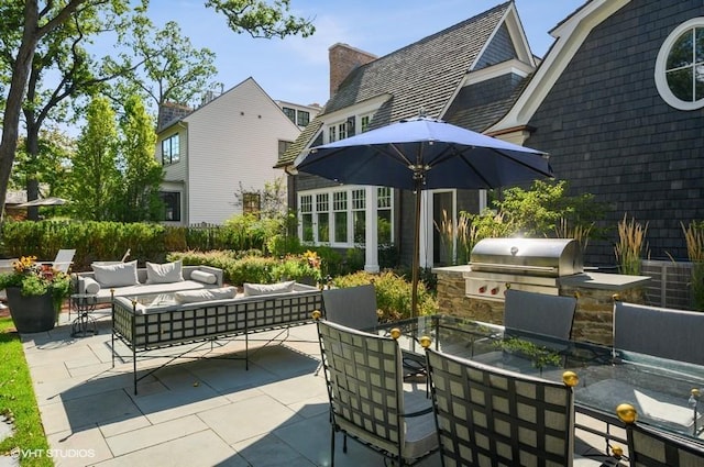 view of patio / terrace featuring an outdoor kitchen, a grill, and an outdoor hangout area