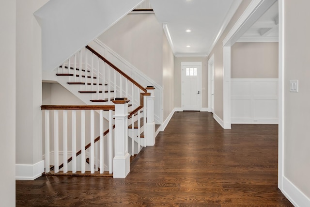 entrance foyer with dark hardwood / wood-style flooring and crown molding