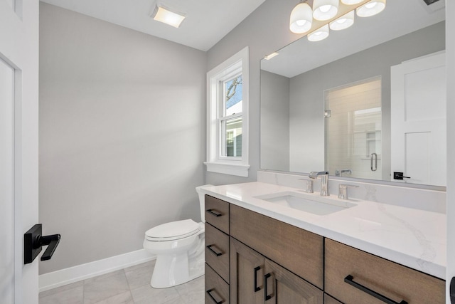 bathroom featuring toilet, vanity, and an enclosed shower