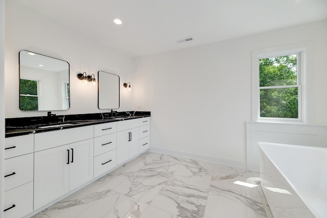 bathroom featuring a bathing tub and vanity