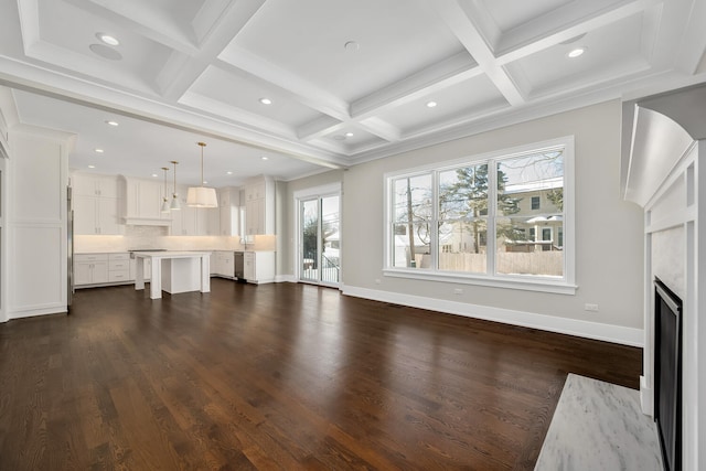 unfurnished living room featuring dark hardwood / wood-style flooring, beam ceiling, a premium fireplace, and coffered ceiling