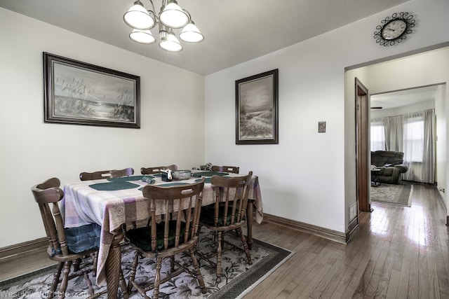 dining room featuring a chandelier and dark hardwood / wood-style flooring