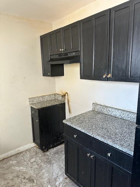 kitchen with light stone countertops