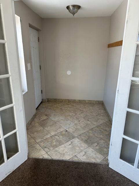 unfurnished room featuring french doors