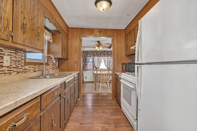 kitchen featuring dark hardwood / wood-style flooring, sink, white appliances, and decorative backsplash