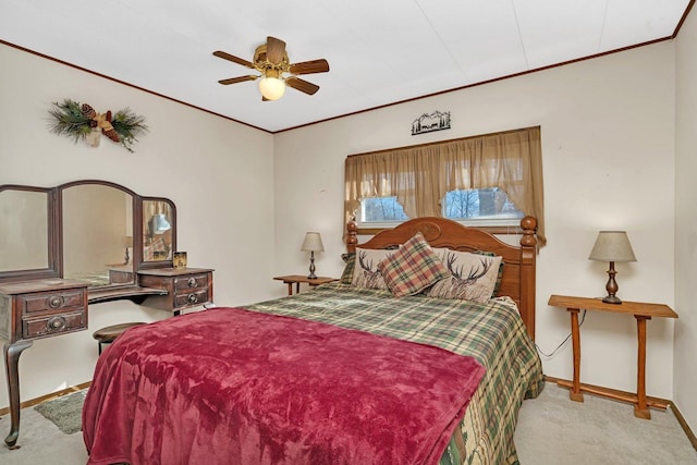 carpeted bedroom with crown molding and ceiling fan