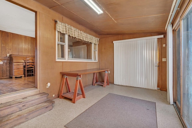 misc room with wood ceiling, wooden walls, and vaulted ceiling