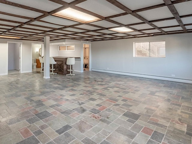 basement featuring baseboard heating and bar