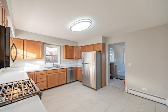 kitchen featuring baseboard heating, sink, and stainless steel appliances