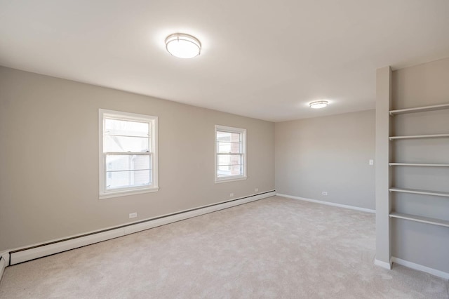 carpeted empty room featuring a baseboard radiator