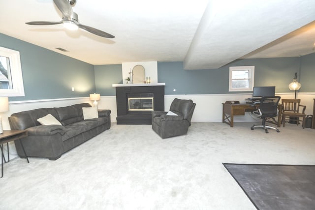 living room with carpet flooring and ceiling fan