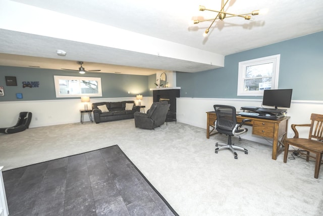 carpeted home office with ceiling fan