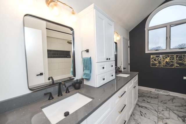 bathroom with lofted ceiling and vanity