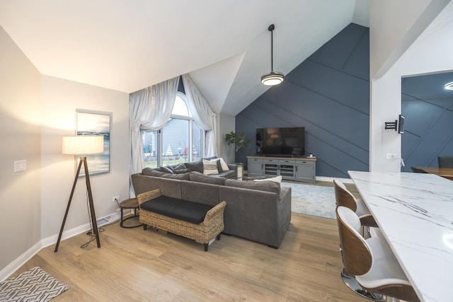 living room with light hardwood / wood-style floors and lofted ceiling