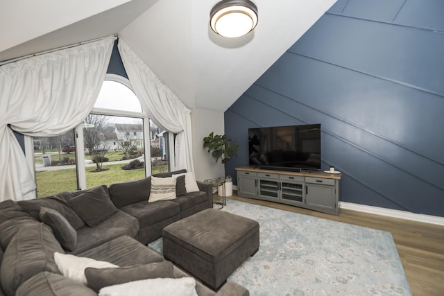 living room featuring lofted ceiling and hardwood / wood-style flooring