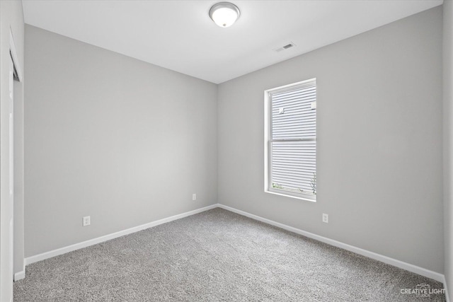 carpeted spare room featuring a healthy amount of sunlight