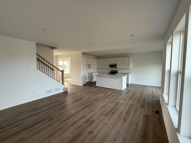 unfurnished living room with dark hardwood / wood-style floors