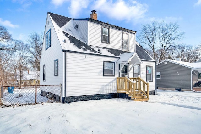 view of snow covered back of property