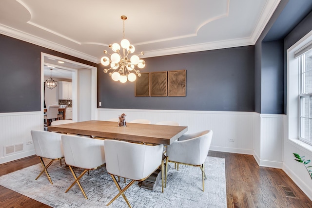 dining room featuring an inviting chandelier, dark hardwood / wood-style floors, and crown molding