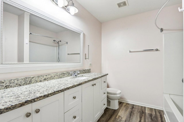 full bathroom with vanity, shower / bathing tub combination, wood-type flooring, and toilet