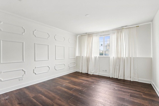 unfurnished room with dark hardwood / wood-style flooring and ornamental molding