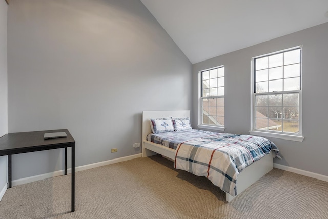 carpeted bedroom featuring vaulted ceiling and baseboards