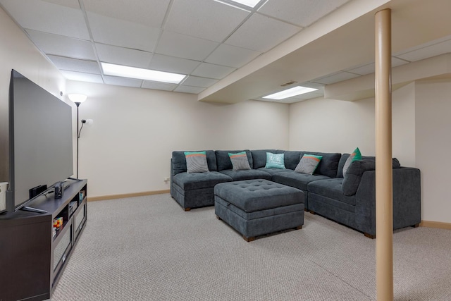 carpeted living area with visible vents, baseboards, and a drop ceiling