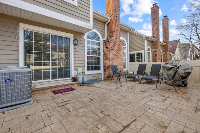 view of patio featuring central air condition unit and a grill