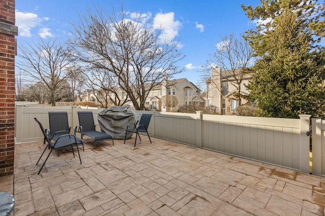 view of patio / terrace featuring fence private yard and a residential view