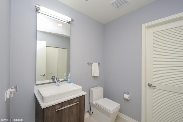 bathroom featuring vanity and toilet