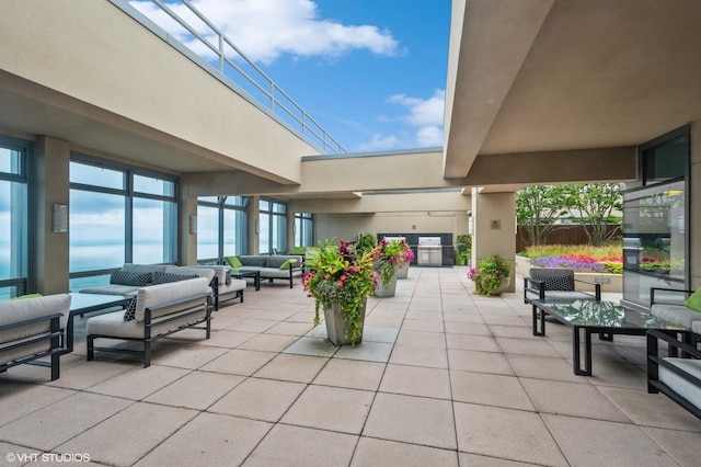 view of patio featuring a water view and outdoor lounge area