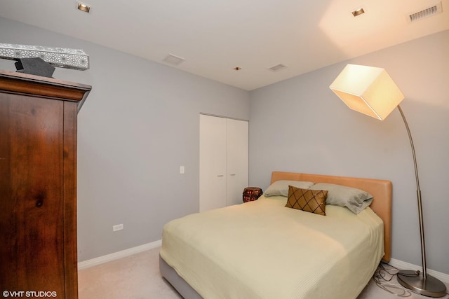 bedroom with light colored carpet and a closet