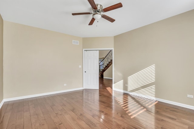 unfurnished room with ceiling fan and hardwood / wood-style flooring