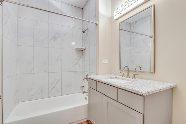 bathroom with vanity and tiled shower / bath