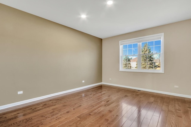 unfurnished room featuring hardwood / wood-style flooring