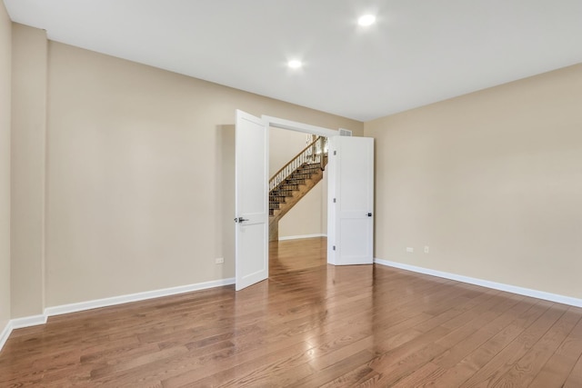 spare room with hardwood / wood-style floors