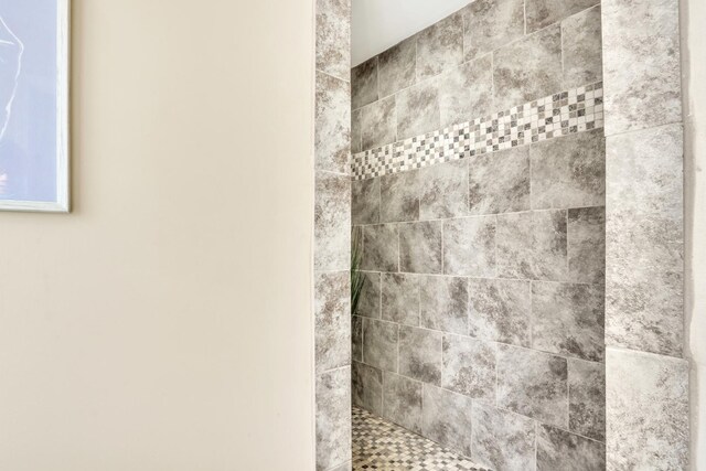 bathroom with tiled shower