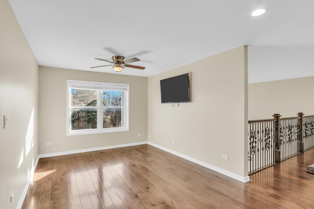 empty room featuring ceiling fan and hardwood / wood-style flooring