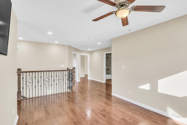 unfurnished room featuring light hardwood / wood-style floors and ceiling fan