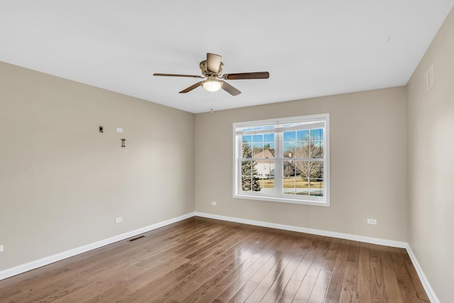 spare room with ceiling fan and hardwood / wood-style flooring