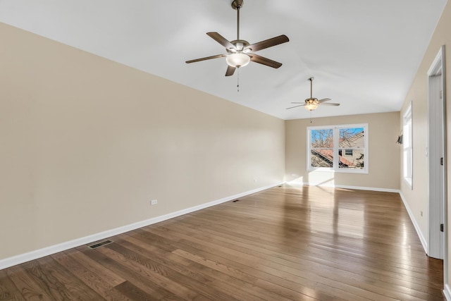 empty room with ceiling fan and dark wood-type flooring