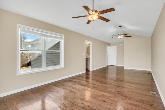 unfurnished room with ceiling fan, vaulted ceiling, and dark hardwood / wood-style flooring