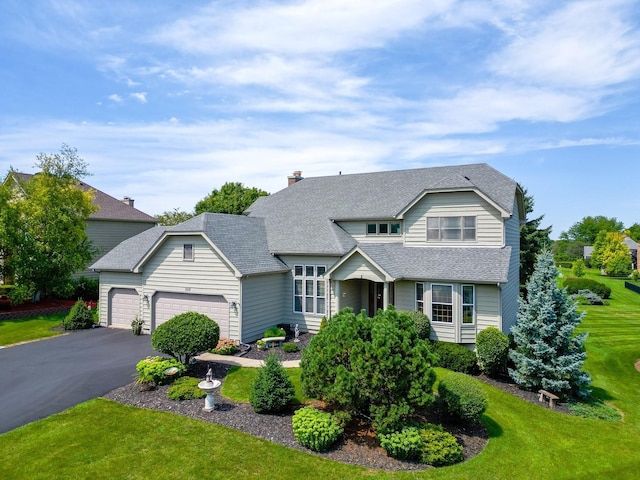 view of front of home featuring a front lawn and a garage