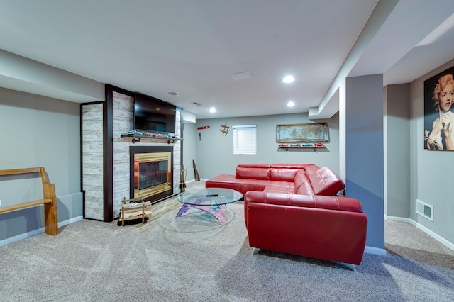 carpeted living room featuring a large fireplace