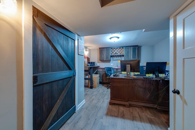 office featuring built in desk and light hardwood / wood-style floors